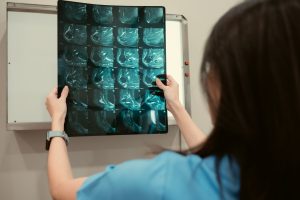 Doctor and patient's x-ray film in hospital examination room